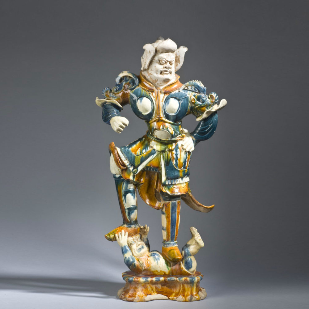 A sancai and predominantly blue glazed earthenware Lokapala